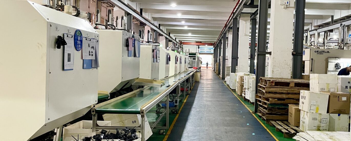 Plastic injection molding production workshop with rows of molding machines