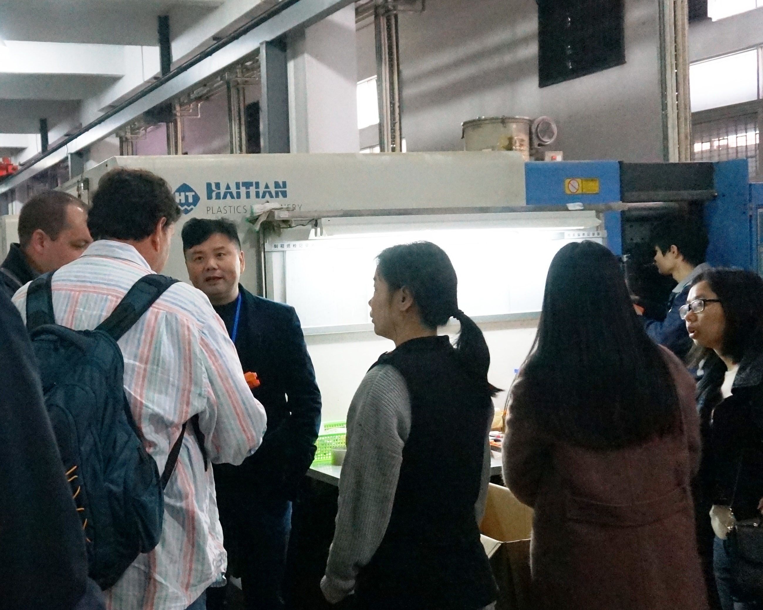 PlasticNavi team discussing a project in the production area